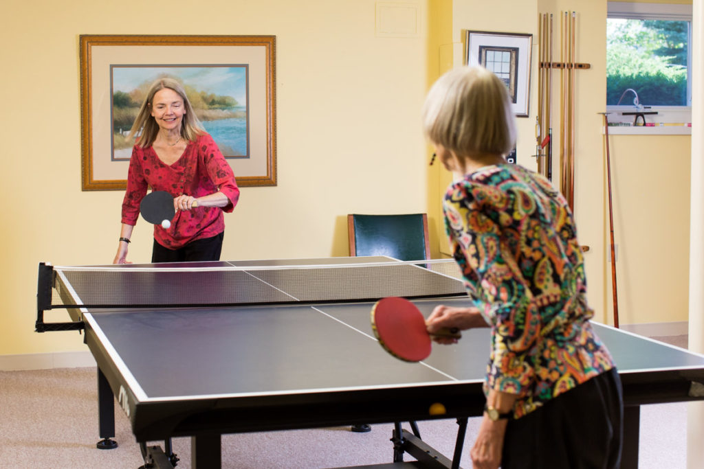 two women playing ping pong